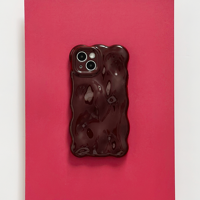 Burgundy Coconut Lane 3D Bubble phone case on a phone, set against a bright red background.