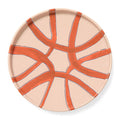 Ceramic plate with orange abstract design on a beige background