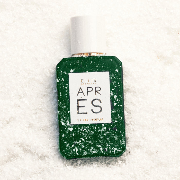 Apres 50ml Eau De Parfum in snow with snow lightly covering bottle.