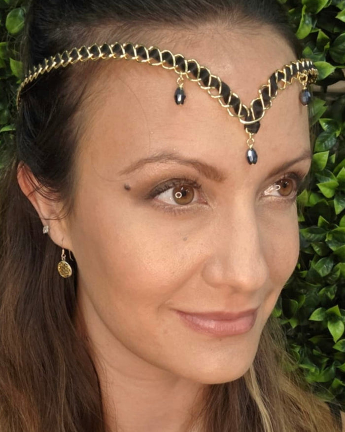 Model wearing gold braided wire forehead crown with crystal drop accents and center dangle.