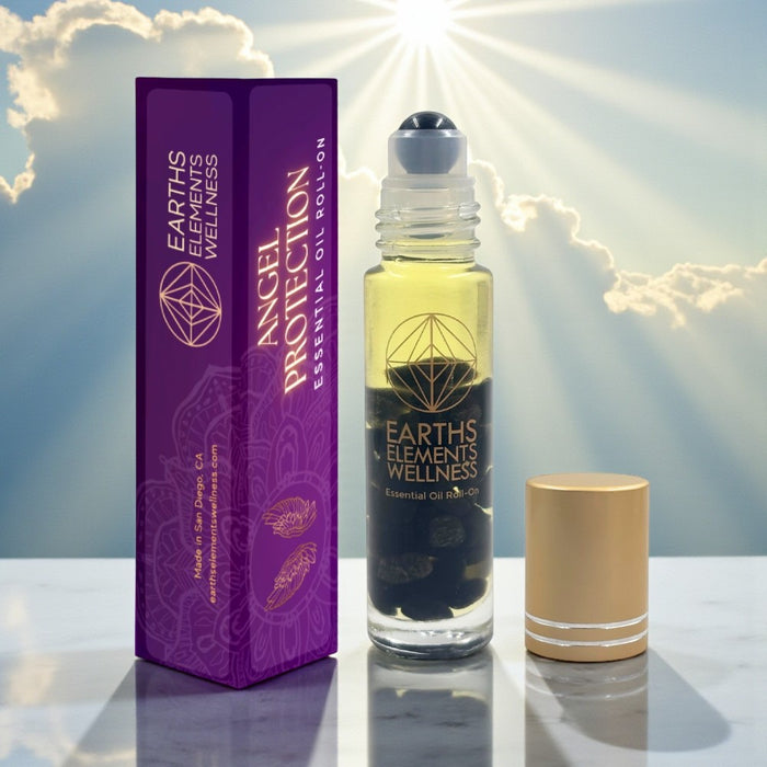 Earth's Elements Wellness essential oil bottle and packaging on a reflective surface with a bright light effect.