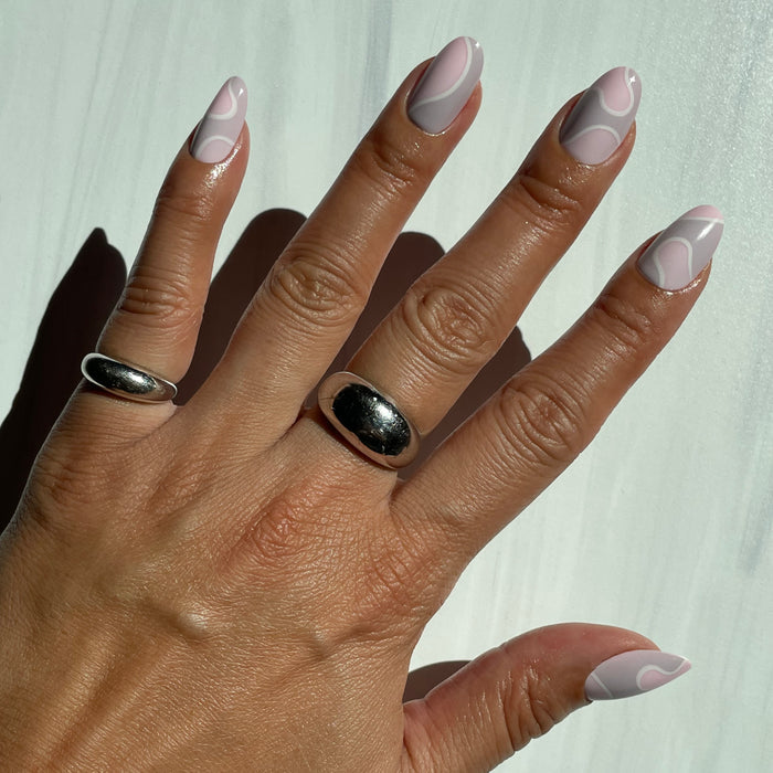 Groovy Swirl - Press-On | Short | Round pink and lavender false nails with a playful swirl for an easy at-home manicure.