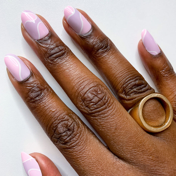 Groovy Swirl - Press-On | Short | Round pink and lavender round press-on nails with white swirl for a stylish mani