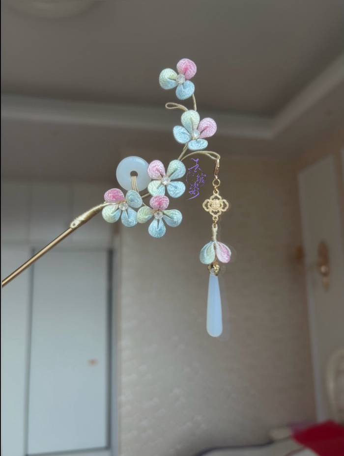 A handmade Chanhua hydrangea - styled hairpin with pastel - colored petals and a tassel-4
