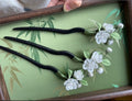 Handmade Chanhua jasmine hairpins with white flowers and green leaves on black pins