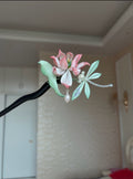 A handmade Chanhua lotus hairpin with pink petals, green leaves, a dragonfly, and pearls