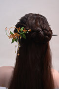 A woman wearing a handmade Chanhua osmanthus sandalwood hairpin in her hair