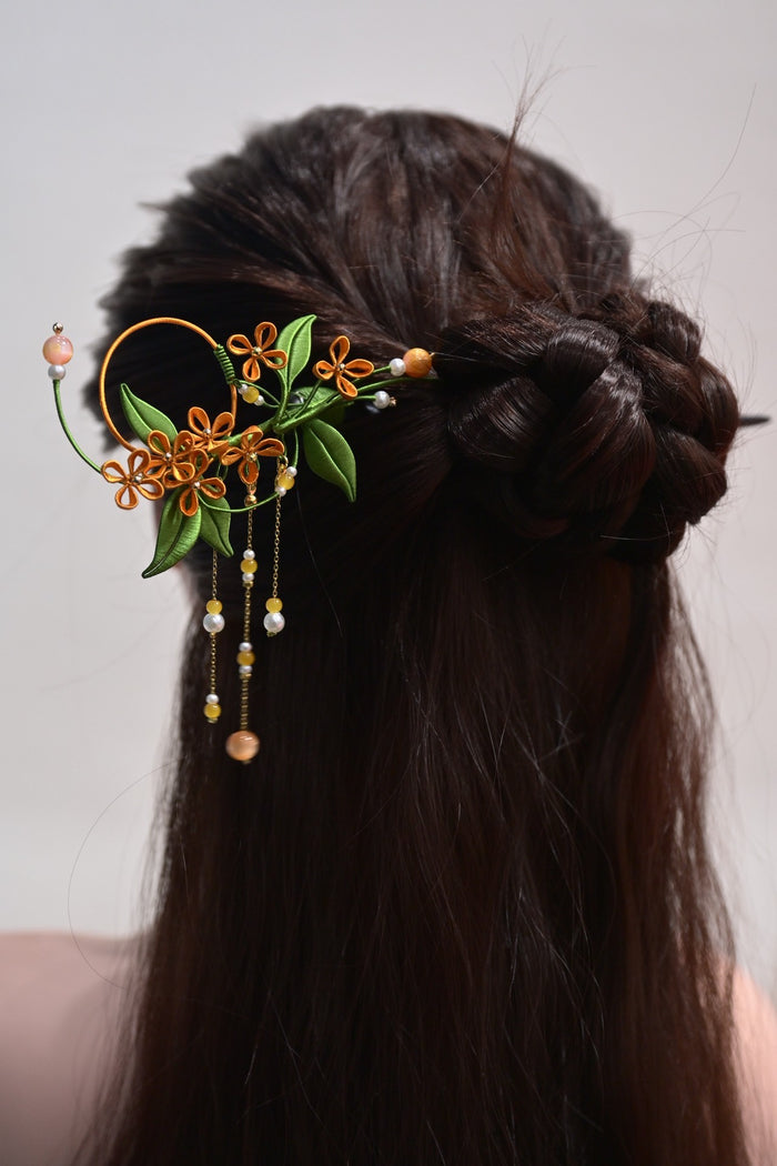 A woman wearing a handmade Chanhua osmanthus sandalwood hairpin in her hair-2