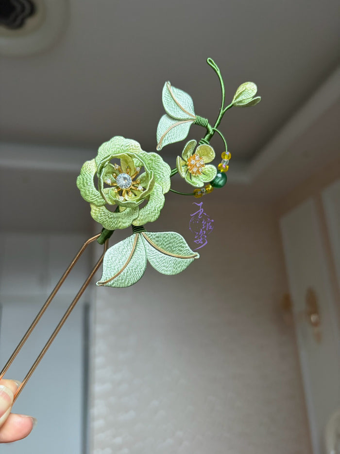 A handmade Chanhua peony hairpin with green petals and leaves