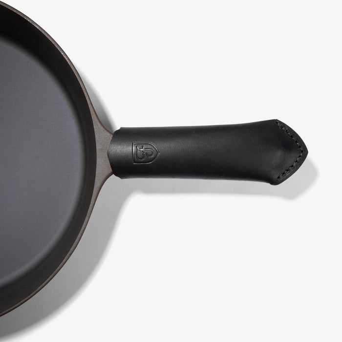 Black Field Leather Handle Cover with stitched tip fitted on the handle of the Field Skillet, seen from above