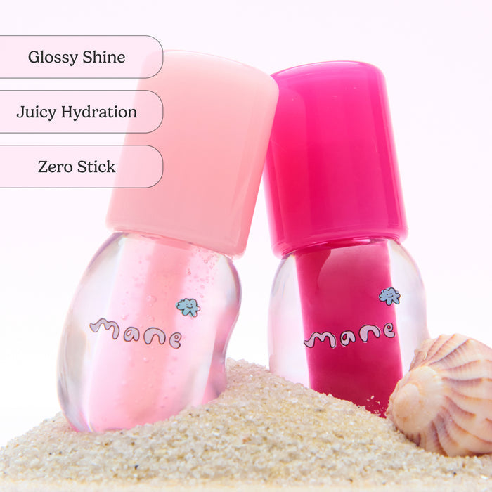 Two pink bottles labeled 'mane' on a sandy background with text describing features.