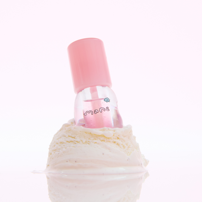 Pink lip gloss bottle with a decorative cap on a white background