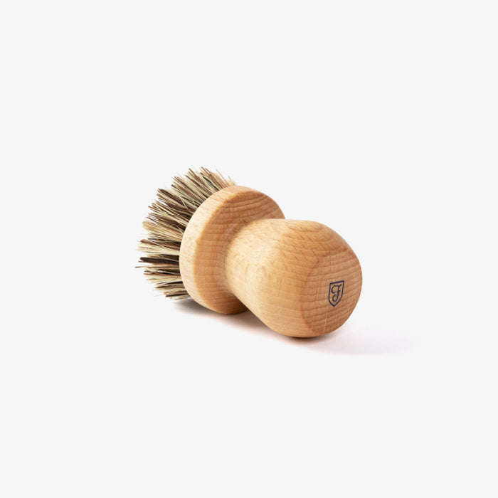 Field Natural Fiber Cleaning Brush on its side, showing beechwood knob handle and stiff bristles