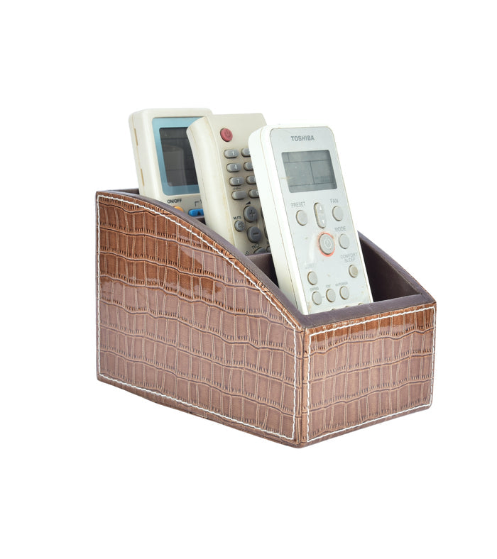Brown croc-textured remote holder with three slots and curved front, housing remotes