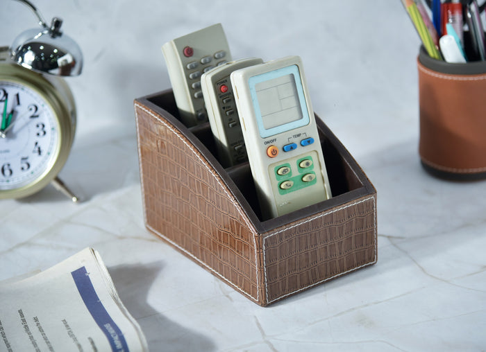 Brown croc-textured remote holder with three open compartments, curved edges