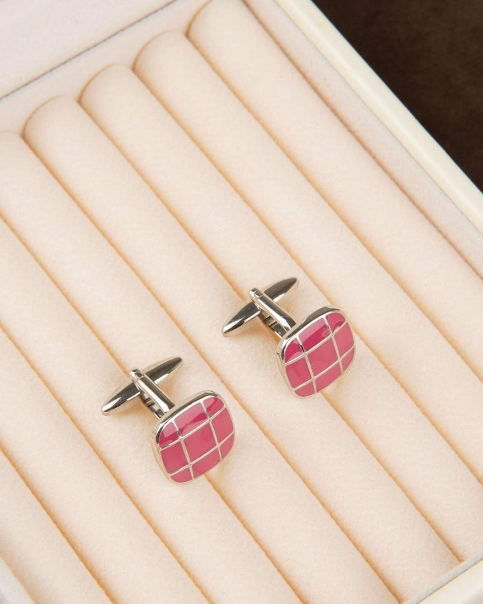 Square silver cufflinks with pink grid enamel on white display pad