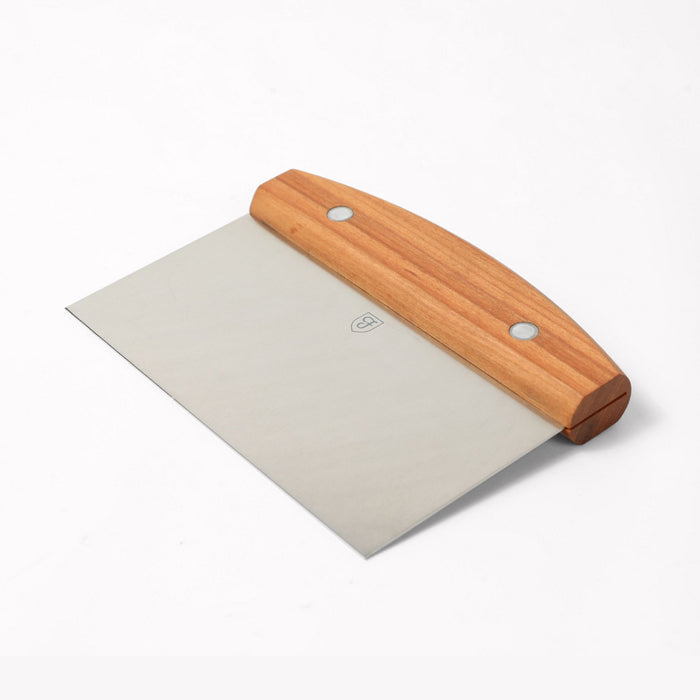 Angled view of the Field Bench Scraper with cherry wood handle and stainless steel blade