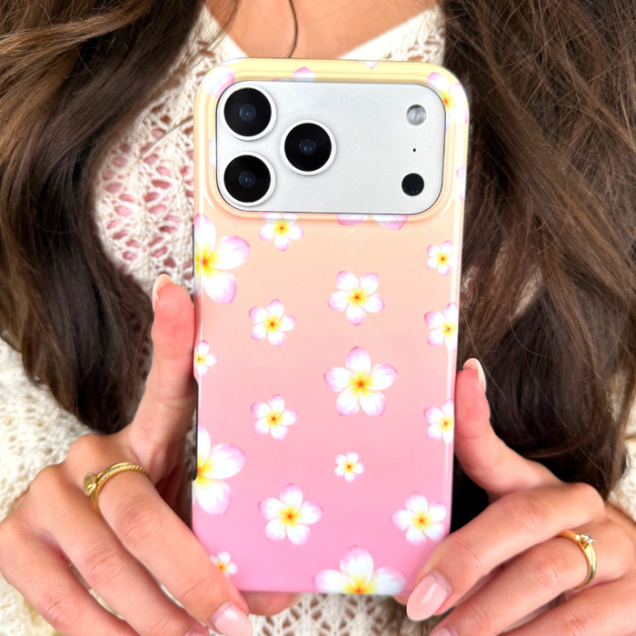 Person holding a phone with a floral case