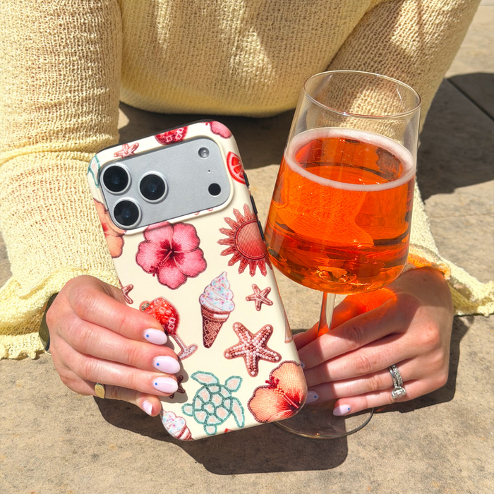 Girl by the pool holding aperol and her Tough MagSafe Island Girl Phone Case