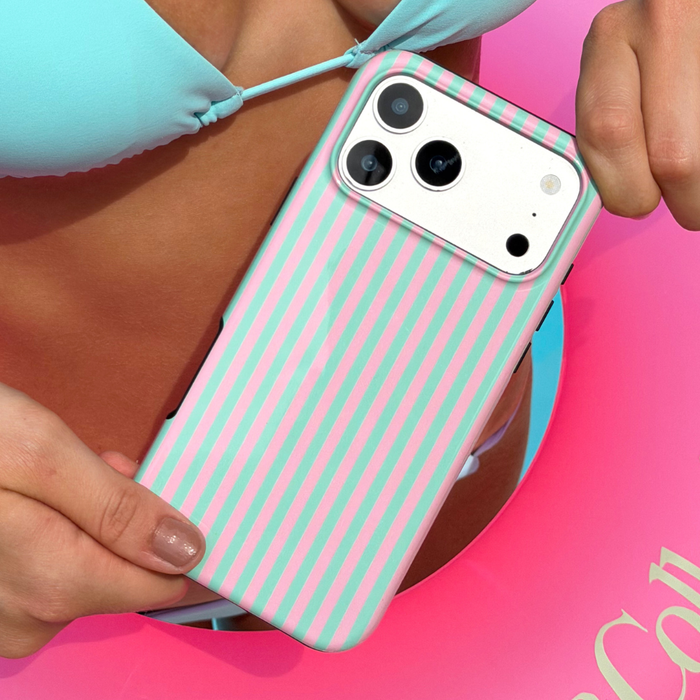 Girl holding a tough phone with a pink and green striped tough phone case, wearing a light blue bikini.