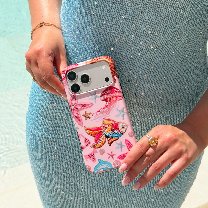 Girl next to pool holding Tough MagSafe Pink Paradise Phone Case