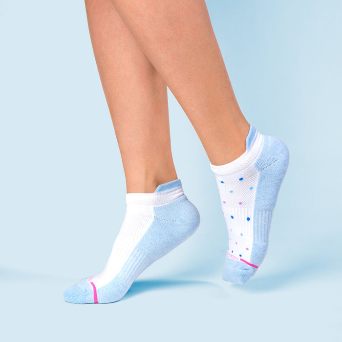 Ankle compression socks in blue and white with colorful dots, shown on a foot against a light blue background.