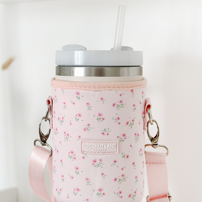 Pink ditsy floral Coconut Lane tumbler carry case with strap, designed to fit travel mugs or large tumblers.
