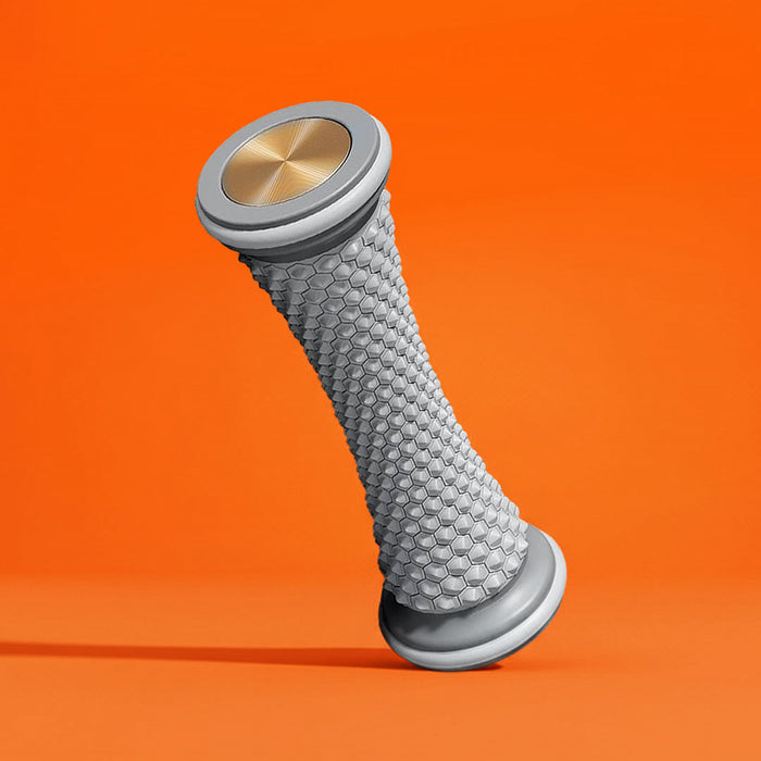 A textured grey and gold foot massage roller floating on an orange backdrop