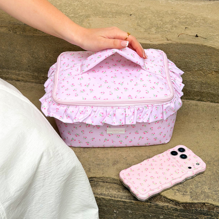 ditsy floral pink phone case next to matching makeup bag