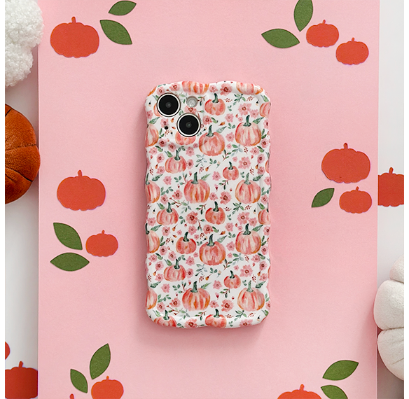 Wavy phone case with pink and orange pumpkins and green leaves in a playful autumn pattern.
