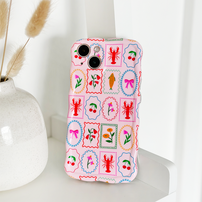 Pink Coconut Lane wavy phone case with stamp-like designs, displayed on a white shelf.