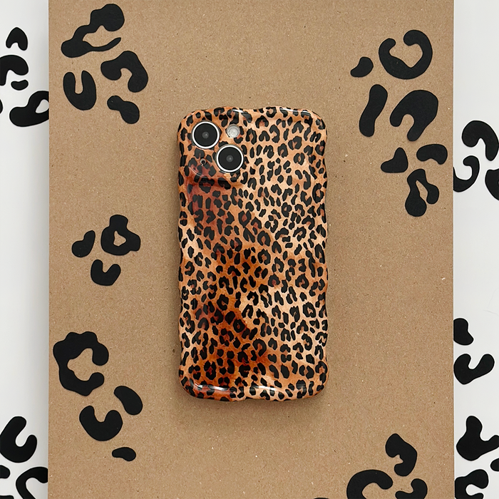 Coconut Lane wavy phone case with black leopard print on a brown background.
