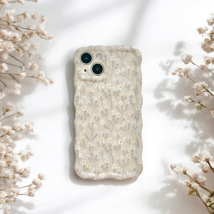 Coconut Lane wavy phone case with nude floral design on a white surface, accented by small white flowers.