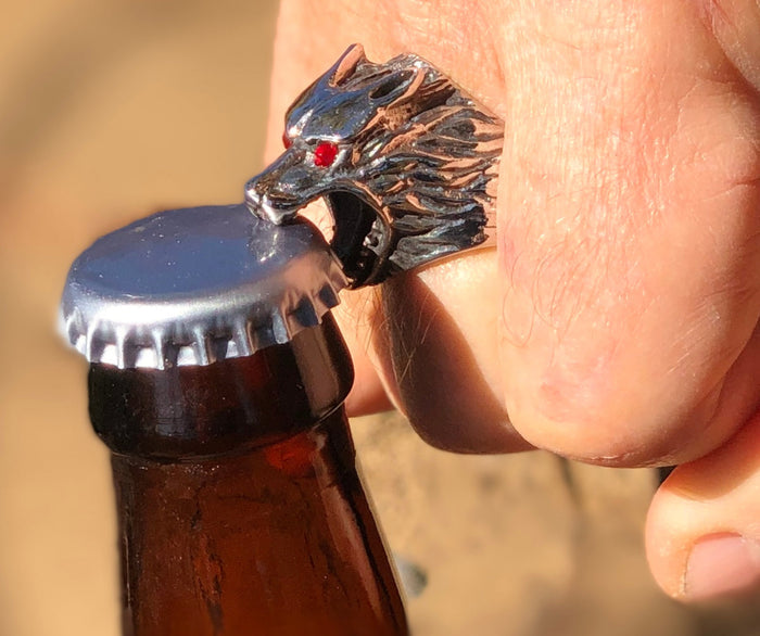 Stainless steel wolf head bottle opener ring opening a beer bottle cap