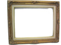 An ornate wooden picture frame with gold leaf detailing and a linen liner, designed for showcasing photographs or artwork.