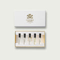 Woody Inspiration Sample Set with gold-embossed white box and five fragrance vials - Flat Lay | Creed Fragrances