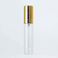 Clear bottle with gold cap on a light gray background