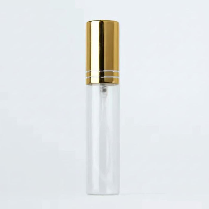 Clear bottle with gold cap on a light gray background